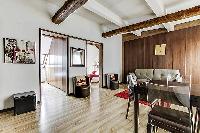 dining area with dining table and four Roche et Bobois chairs in a 2-bedroom Paris luxury apartment