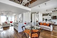 modern living area, dining area, kitchen, bedroom, and bathroom in a 1-bedroom loft Paris luxury apa
