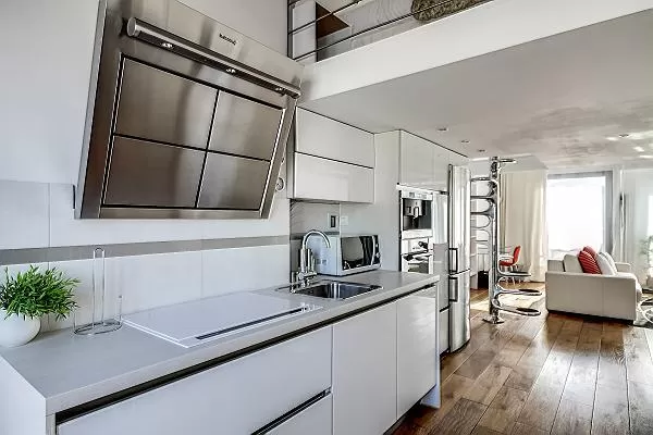 well-equipped white kitchen in a 1-bedroom loft Paris luxury apartment