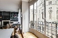 tall French windows overlooking the city in a 2-bedroom paris luxury apartment