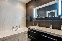 an en-suite bathroom in which a sink, toilet, and a shower area in a 2-bedroom paris luxury apartmen