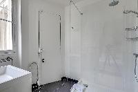an en suite bathroom fully-equipped with a bath, a separate shower area, double sink, a mirror, and 