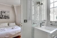 cozy bedroom with an en suite bathroom fully-equipped with a bath, a separate shower area, double si