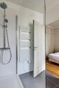 cozy bedroom with an en suite bathroom fully-equipped with a bath, a separate shower area, double si