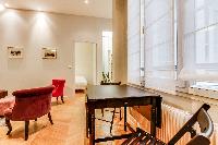 mini dining area for 2 with wooden table and chairs in Paris luxury apartment