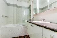 neat and fresh bathroom with tub in Champs Elysées - Paul Baudry 1 bedroom luxury apartment