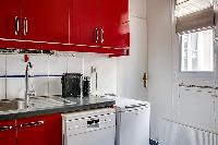 red and white kitchen in a 3-bedroom Paris luxury apartment