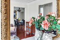 flower vase in front of the mirror in the living room of a 3-bedroom Paris luxury apartment