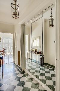 black and white tiled-floor and mirrored walls in a 1-bedroom Paris luxury apartment