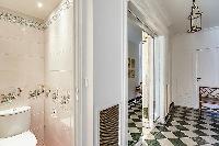 A water closet beside the bathroom with a toilet and a sink in Paris luxury apartment