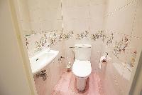 A water closet beside the bathroom with a toilet and a sink in Paris luxury apartment