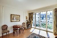 living area illuminated by the French windows that line the sides, giving the room a fresh and vibra