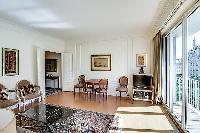 living area illuminated by the French windows that line the sides, giving the room a fresh and vibra