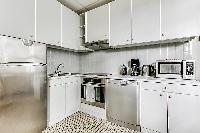 fully-equipped kitchen in a 3-bedroom Paris luxury apartment