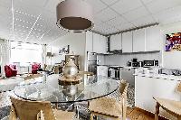 fully-equipped kitchen with four-seater dining set in a 3-bedroom Paris luxury apartment