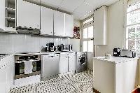 fully-equipped kitchen in a 3-bedroom Paris luxury apartment