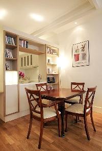 dining area with a table and four chairs in a 1-bedroom Paris luxury apartment