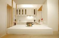 pristine white fully-equipped kitchen in a 1-bedroom Paris luxury apartment