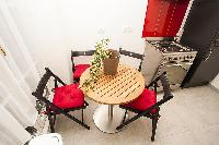 modern well-equipped kitchen with small dining table and 4 seats in a 2-bedroom Paris luxury apartme