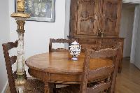 dining area with dining room cabinet, and table with four chairs in a 2-bedroom Paris luxury apartme