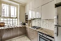 well-equipped kitchen in a 1-bedroom Paris luxury apartment