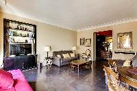 tastefully decorated 1-bedroom Paris luxury apartment in a traditional style, with gold, brown, and 