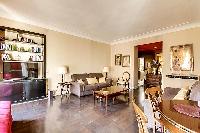 tastefully decorated 1-bedroom Paris luxury apartment in a traditional style, with gold, brown, and 