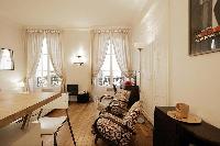 a space efficient studio Paris luxury apartment with immaculate white walls and golden oak floors