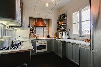 well-equipped kitchen in a 3-bedroom Paris luxury apartment