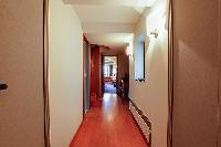 bright-floored hallway with wall lamps in a 3-bedroom Paris luxury apartment