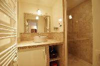 bathroom with sink and shower in a 2-bedroom Paris luxury apartment