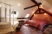 second bedroom with 2 single bed formed to make a queen size bed, ensuite bathroom, and exposed beam