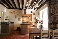 cozy dining area and kitchen with exposed beams in a 2-bedroom Paris luxury apartment