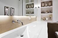 bathroom sink, mirror, and shelves in a Paris luxury apartment