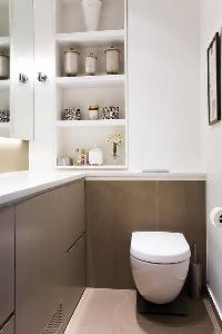 toilet with shelves and built-in cabinets in Paris luxury apartment