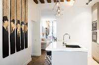 modern yet classy kitchen with breakfast bar and stools in Paris luxury apartment