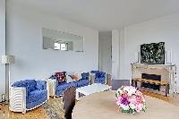 well-lit living area and dining area in Paris luxury apartment