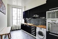 fully-equipped kitchen in a 3-bedroom Paris luxury apartment