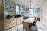 beautiful white and blue-themed kitchen in a 3-bedroom Paris luxury apartment