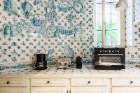 beautiful white and blue-themed kitchen in a 3-bedroom Paris luxury apartment