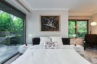 chic bedroom overlooking the courtyard  in a 4-bedroom Paris luxury apartment