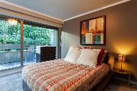 second bedroom with double bed, a chest of drawers, and bedside tables in a 4-bedroom Paris luxury a