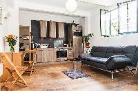 spacious living area, dining area, and kitchen in Paris luxury apartment