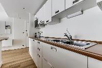 well-equipped space-efficient kitchen in a 1-bedroom paris luxury apartment