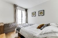 cozy bedroom fully-furnished with a small desk, automated blackout shutters, double-glazed windows, 