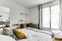 cozy bedroom fully-furnished with a small desk, automated blackout shutters, double-glazed windows, 