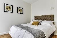 cozy bedroom fully-furnished with a small desk, automated blackout shutters, double-glazed windows, 