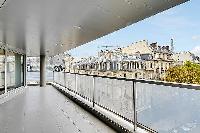 wraparound balcony with access to the living area and dining area with stunning view the Eiffel Towe