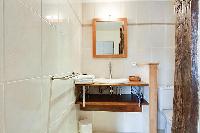 sleek bathroom sink and toilet in a 1-bedroom Paris luxury apartment