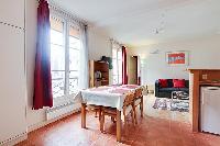 dining area with a table and four chairs in a 1-bedroom Paris luxury apartment